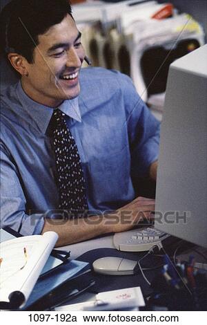 desk, headset, smiling, telephone, Asian, Hispanic View Large Photo Image Stock Image - desk, headset, smiling, telephone, Asian, Hispanic. Fotosearch