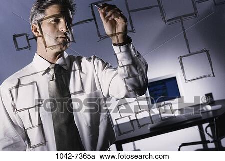 Stock Image - desk, Hispanic, computer, chart, business. Fotosearch