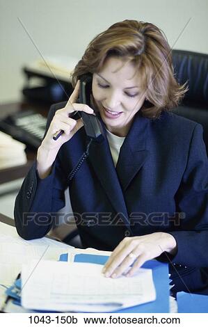 desk, woman, telephone, talking, paperwork, discussion, conversation View Large Photo Image Stock Image - desk, woman, telephone, talking, paperwork, discussion, conversation. Fotosearch