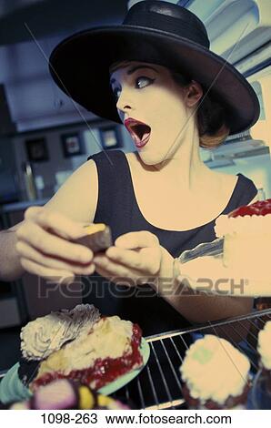 eating, home, woman, hat, refrigerator, secretive, surprise View Large Photo Image Stock Image - eating, home, woman, hat, refrigerator, secretive, surprise. Fotosearch