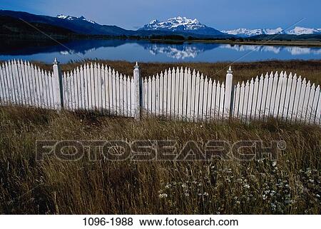 Stock Photo - grass, fence, lake, mountains, ornamental, Chile, picket. Fotosearch