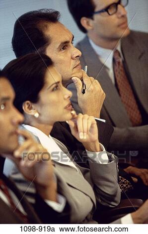 Stock Image - meeting, group, multiethnic, attentive, listening, concentrating, business. Fotosearch