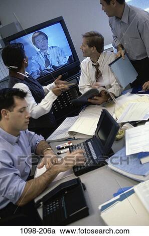 Stock Image - meeting, group, multiethnic, blur, paperwork, discussion, technology. Fotosearch