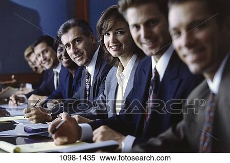 Stock Photography - meeting, group, multiethnic, smiling, table, sitting. Fotosearch