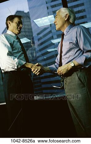 Stock Image - men, contract, deal, business, Middle-aged, greeting, businessmen. Fotosearch