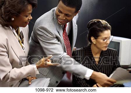 multiethnic, hand, desk, smiling, coworkers, paperwork View Large Photo Image Stock Image - multiethnic, hand, desk, smiling, coworkers, paperwork. Fotosearch