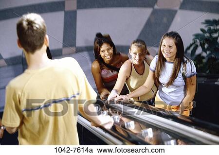 Stock Image - multiethnic, people, escalator, smiling, flirting, looking, shopping. Fotosearch