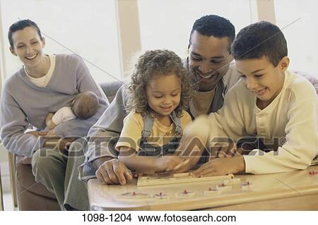 Picture - multiethnic, people, playing, puzzle, family, children. Fotosearch