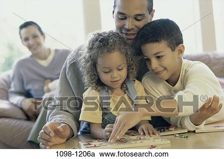 Stock Image - multiethnic, people, puzzle, family, children, game. Fotosearch