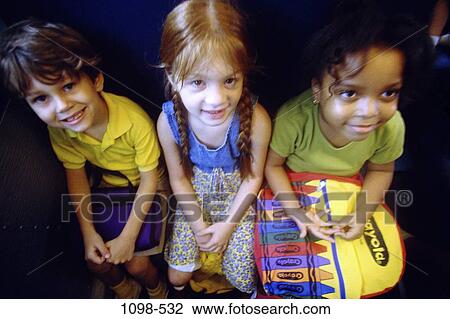 Stock Image - multiethnic, people, sitting, backpack, children, education, student. Fotosearch
