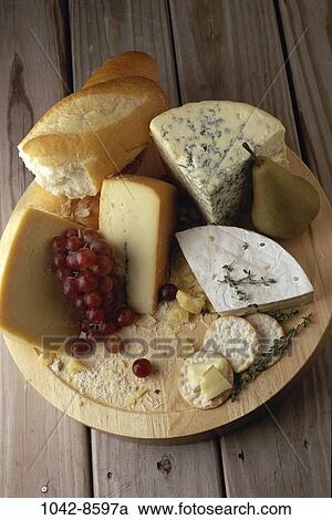 Stock Image - overhead, grapes, pear, plate, bread, assorted, dairy. Fotosearch