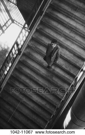 Stock Photo - overhead, steps, stairs, shadows, woman, isolation, business. Fotosearch