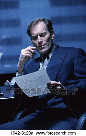 paper, reading, concentrating, business, Middle-aged, serious View Large Photo Image Stock Image - paper, reading, concentrating, business, Middle-aged, serious. Fotosearch