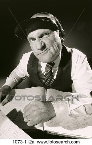 Stock Image - paperwork, ledger, books, Middle-aged, contemplation, contemplating. Fotosearch