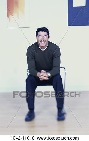 Stock Photo - people, blur, smiling, listening, sitting, smile. Fotosearch