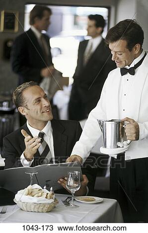 Stock Image - people, cafe, business, restaurant, waiter, menu, ordering. Fotosearch