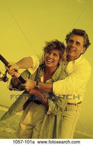 Stock Image - people, couple, beach, outdoors, Middle-aged, fishing, Middle-aged sports fishing. Fotosearch