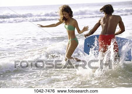people, couple, beach, outdoors, vacation, teens, surfboard View Large Photo Image Stock Photograph - people, couple, beach, outdoors, vacation, teens, surfboard. Fotosearch