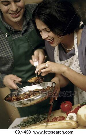 people, eating, couple, cooking, laughing, kitchen, brunette View Large Photo Image Stock Image - people, eating, couple, cooking, laughing, kitchen, brunette. Fotosearch