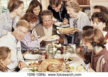 Stock Image - people, eating, family, parents, indoors, eat, Families indoors eating. Fotosearch