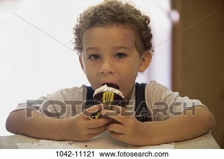 Stock Image - people, eating, licking, boy, child, snack, food. Fotosearch