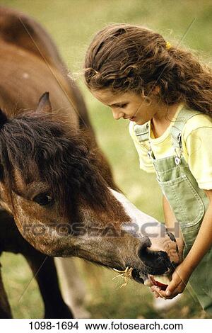 people, eating, pet, girl, horse, outdoors, friends View Large Photo Image Picture - people, eating, pet, girl, horse, outdoors, friends. Fotosearch