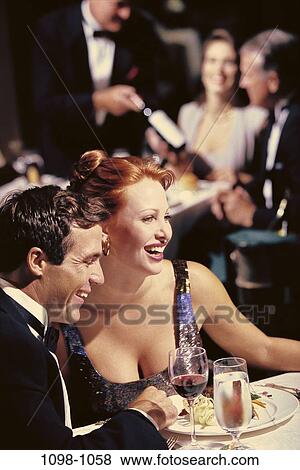 people, formal, smiling, glasses, couple, sitting, wine View Large Photo Image Stock Photo - people, formal, smiling, glasses, couple, sitting, wine. Fotosearch