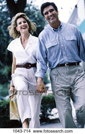 Picture - people, hand, smiling, walking, shirt, laughing, holding. Fotosearch