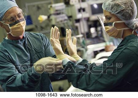 Stock Image - people, hands, table, scrubs, surgery, operating, equipment. Fotosearch
