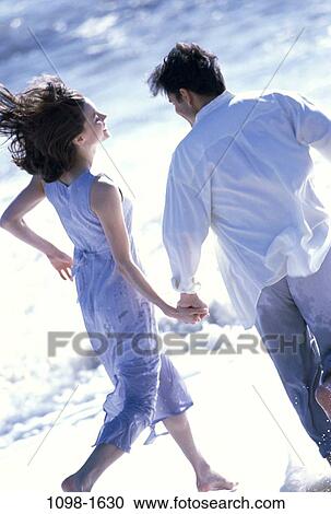 people, hands, water, running, playing, couple, beach View Large Photo Image Stock Image - people, hands, water, running, playing, couple, beach. Fotosearch