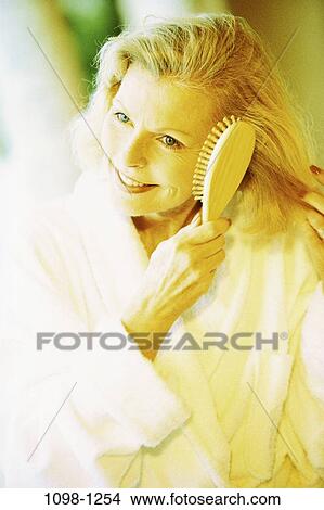 people, home, woman, hair, brushing, Middle-aged, blond View Large Photo Image Picture - people, home, woman, hair, brushing, Middle-aged, blond. Fotosearch