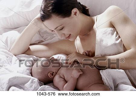 people, mother, baby, bed, family, admiring View Large Photo Image Stock Photograph - people, mother, baby, bed, family, admiring. Fotosearch