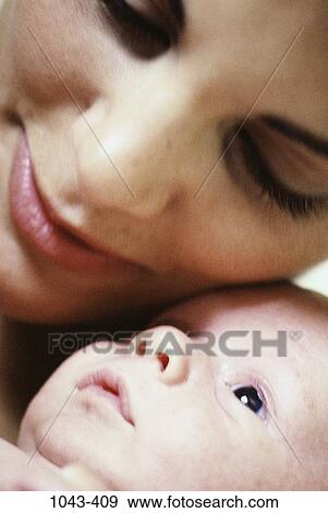 Stock Photo - people, mother, baby, family, affection, close, caring. Fotosearch
