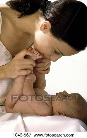 Stock Photo - people, mother, baby, playful, family, feet, affection. Fotosearch