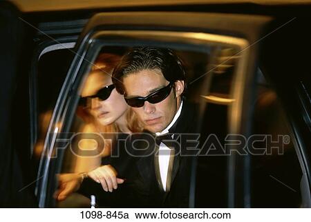 Stock Image - people, night, limousine, couple, door, car, sunglasses. Fotosearch