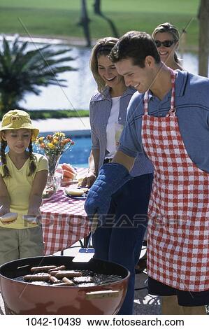 Stock Photo - people, picnic, summer, outdoors, family, food, apron. Fotosearch