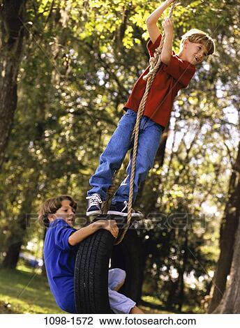 people, playing, climbing, swinging, swing, outdoors, friends View Large Photo Image Stock Image - people, playing, climbing, swinging, swing, outdoors, friends. Fotosearch