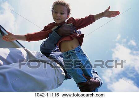 people, playing, flying, happy, stretching, holding, outdoors View Large Photo Image Stock Photograph - people, playing, flying, happy, stretching, holding, outdoors. Fotosearch