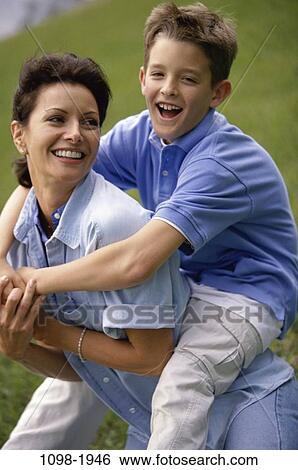 people, playing, mother, riding, outdoors, carrying, family View Large Photo Image Stock Photograph - people, playing, mother, riding, outdoors, carrying, family. Fotosearch