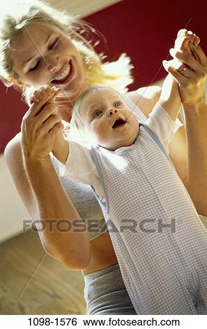 people, progress, smiling, mother, baby, raised, holding View Large Photo Image Stock Photograph - people, progress, smiling, mother, baby, raised, holding. Fotosearch