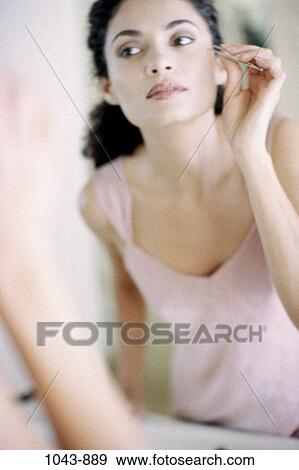 people, reflection, woman, Hispanic, mirror, tweezers, cosmetics View Large Photo Image Stock Photo - people, reflection, woman, Hispanic, mirror, tweezers, cosmetics. Fotosearch