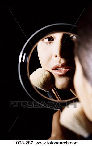 Stock Photo - people, reflection, woman, Hispanic, mirror, makeup, contemplation. Fotosearch