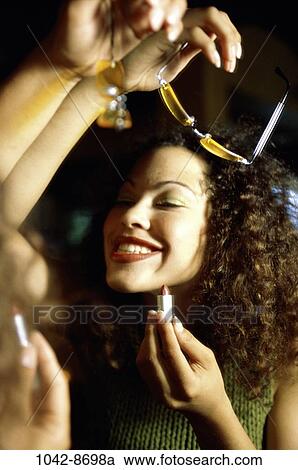 Stock Image - people, reflection, woman, smiling, Hispanic, hair, sunglasses. Fotosearch