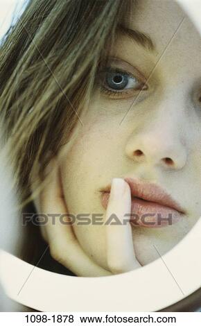 Stock Photo - people, reflection, woman, staring, face, mirror, reflecting. Fotosearch