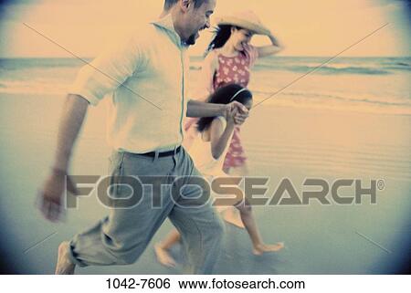 people, running, hat, Hispanic, blue, beach, playful View Large Photo Image Stock Photograph - people, running, hat, Hispanic, blue, beach, playful. Fotosearch