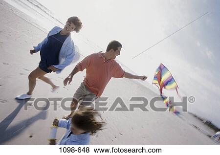 people, running, playing, flying, beach, playful View Large Photo Image Stock Photo - people, running, playing, flying, beach, playful. Fotosearch