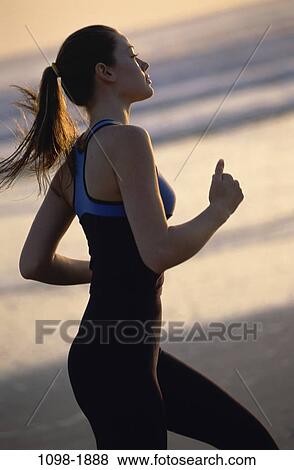 Stock Photo - people, running, woman, Hispanic, healthy, beach, jogging. Fotosearch