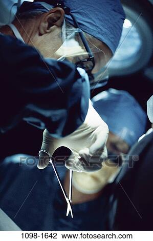 Stock Image - people, scrubs, surgery, doctor, operating, surgeon. Fotosearch