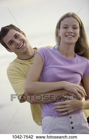 people, smiling, couple, beach, laughing, hugging, smile View Large Photo Image Stock Image - people, smiling, couple, beach, laughing, hugging, smile. Fotosearch
