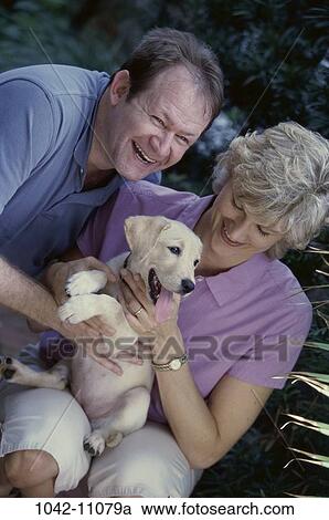 people, smiling, dog, couple, puppy, sitting, pet View Large Photo Image Stock Image - people, smiling, dog, couple, puppy, sitting, pet. Fotosearch